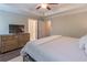 Bright bedroom boasting a ceiling fan, neutral walls, and a wood dresser with dark brown hardwood floors at 1382 Doublegate Ne Dr, Atlanta, GA 30319