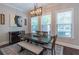 Dining area features a table with seating for six, a modern chandelier, and natural light at 1382 Doublegate Ne Dr, Atlanta, GA 30319