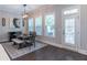 Dining area with stylish lighting fixture, natural light from windows, and access to outdoor deck at 1382 Doublegate Ne Dr, Atlanta, GA 30319