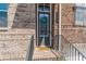 Up-close exterior shot of the front door with a welcome mat, wreath, address, and brick facade at 1382 Doublegate Ne Dr, Atlanta, GA 30319