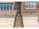 Brick townhome with a staircase leading to the front door, two garage doors, and symmetrical window placements at 1382 Doublegate Ne Dr, Atlanta, GA 30319