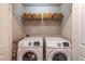 Laundry room area includes two Samsung washers and a wire shelf with four woven storage baskets at 1382 Doublegate Ne Dr, Atlanta, GA 30319
