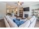 Open living room showcasing a fireplace, large couch, decorative shelves, and an open view to the kitchen at 1382 Doublegate Ne Dr, Atlanta, GA 30319