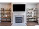 Living room featuring a fireplace with a large television above, and custom shelving on either side at 1382 Doublegate Ne Dr, Atlanta, GA 30319