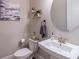 Stylish powder room with a modern sink, round mirror, and decorative wall art at 1382 Doublegate Ne Dr, Atlanta, GA 30319
