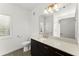 Modern bathroom with a dark vanity, quartz countertop, and a large mirror with light fixtures at 19 Moda Ln, Atlanta, GA 30316