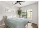 Bright bedroom with large windows, a ceiling fan and a minimalist aesthetic featuring a light wood frame bed at 19 Moda Ln, Atlanta, GA 30316