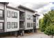 Modern three-story townhome showcasing gray siding, dark trim, and small balconies at 19 Moda Ln, Atlanta, GA 30316