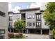 Modern three-story townhome showcasing gray siding, dark trim, and small balconies at 19 Moda Ln, Atlanta, GA 30316