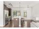 Open-concept kitchen with stainless steel appliances, an island with bar seating and wood floors throughout at 19 Moda Ln, Atlanta, GA 30316