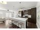 Modern kitchen features an island with seating, stainless steel appliances, and ample storage space at 19 Moda Ln, Atlanta, GA 30316