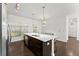 Kitchen island featuring a stainless steel sink with wood cabinets and hardwood floors at 19 Moda Ln, Atlanta, GA 30316