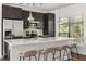 Modern kitchen with stainless appliances, island with seating, white countertops and dark cabinets, bathed in natural light at 19 Moda Ln, Atlanta, GA 30316