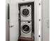 Efficient laundry closet with stacked washer and dryer unit and white walls at 19 Moda Ln, Atlanta, GA 30316
