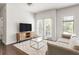 Cozy living room featuring a large TV and a modern glass coffee table at 19 Moda Ln, Atlanta, GA 30316