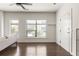 Open living area with hardwood floors, large windows, and an adjacent door and a view into other rooms at 19 Moda Ln, Atlanta, GA 30316