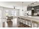 Bright, open living space features hardwood floors, a kitchen island with seating and stainless steel appliances at 19 Moda Ln, Atlanta, GA 30316