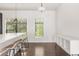 Open floor plan featuring kitchen island with seating, dark hardwood floors, and ample natural light from surrounding windows at 19 Moda Ln, Atlanta, GA 30316