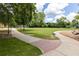 Beautiful grassy field with paved walking path, park benches and playground equipment in the background at 19 Moda Ln, Atlanta, GA 30316