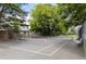 Exterior shot of community tennis court surrounded by green trees and fencing at 19 Moda Ln, Atlanta, GA 30316