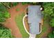 Overhead view of a house showcasing its roof, landscaping, and wooded surroundings at 4800 Timberland Sw Dr, Mableton, GA 30126
