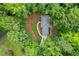 Aerial view of the house set within a lush green, mature wooded landscape at 4800 Timberland Sw Dr, Mableton, GA 30126