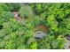 Aerial image shows mature trees surrounding the home and the lot it resides on at 4800 Timberland Sw Dr, Mableton, GA 30126