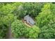 Overhead view of home surrounded by lush trees and landscaping showing its serene wooded lot at 4800 Timberland Sw Dr, Mableton, GA 30126