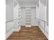 Large walk-in closet with built-in shelving and drawers at 4800 Timberland Sw Dr, Mableton, GA 30126