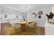 Bright dining area with modern chandelier, mirrors, decor, and an open floor plan leading to the kitchen at 4800 Timberland Sw Dr, Mableton, GA 30126