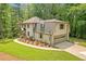 Home with a two-car garage, surrounded by a lush lawn and beautiful landscaping at 4800 Timberland Sw Dr, Mableton, GA 30126