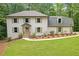 Charming home featuring a well-manicured lawn and lush landscaping, complete with shuttered windows at 4800 Timberland Sw Dr, Mableton, GA 30126