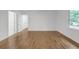 Hallway boasts hardwood floors, multiple doors with gold hardware, and a window letting in natural light at 4800 Timberland Sw Dr, Mableton, GA 30126