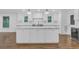 Bright kitchen featuring a large center island with white cabinets, marble countertops, and modern lighting at 4800 Timberland Sw Dr, Mableton, GA 30126