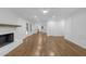 Open-concept living area with hardwood floors, white trim, and a brick fireplace at 4800 Timberland Sw Dr, Mableton, GA 30126