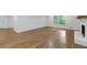 Bright living room featuring hardwood floors, a white brick fireplace, and large windows at 4800 Timberland Sw Dr, Mableton, GA 30126