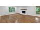 Bright living room featuring hardwood floors, a white brick fireplace, and large windows at 4800 Timberland Sw Dr, Mableton, GA 30126