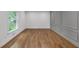 A spacious living room with a large window and decorative wall paneling at 4800 Timberland Sw Dr, Mableton, GA 30126