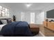 Bright main bedroom featuring hardwood floors, modern furniture, closet, TV, and en-suite bath at 4800 Timberland Sw Dr, Mableton, GA 30126