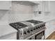 Stainless steel oven range with a decorative backsplash in a modern kitchen at 4800 Timberland Sw Dr, Mableton, GA 30126