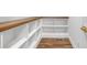 Walk-in pantry boasting wood floor and plenty of white shelving with natural wood trim at 4800 Timberland Sw Dr, Mableton, GA 30126