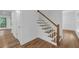 Staircase with hardwood steps, white risers, and a stained wood railing at 4800 Timberland Sw Dr, Mableton, GA 30126