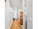 Hallway with hardwood floors, front door, and view to the kitchen with bar seating at 1253 Caroline Ne St # 223, Atlanta, GA 30307