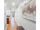 Bright hallway with hardwood floors, modern artwork, and open staircase to upper level at 1253 Caroline Ne St # 223, Atlanta, GA 30307