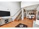 Open-concept living room with hardwood floors, staircase, and dining area at 1253 Caroline Ne St # 223, Atlanta, GA 30307