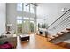 Bright living room with high ceilings, hardwood floors, and staircase to upper level at 1253 Caroline Ne St # 223, Atlanta, GA 30307