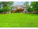 Spacious backyard with a well-maintained lawn, a deck, and a charming two-story home at 2045 Bethany Spring Trce, Cumming, GA 30041