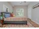 Well-lit bedroom with wood-look floors, grey bed frame, and unique artwork above bed at 2045 Bethany Spring Trce, Cumming, GA 30041