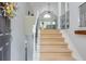 Bright foyer with a staircase featuring modern railing, leading to an open-concept living area at 2045 Bethany Spring Trce, Cumming, GA 30041