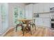 Eat-in kitchen nook with table, chairs, natural light, and modern white cabinetry at 2045 Bethany Spring Trce, Cumming, GA 30041